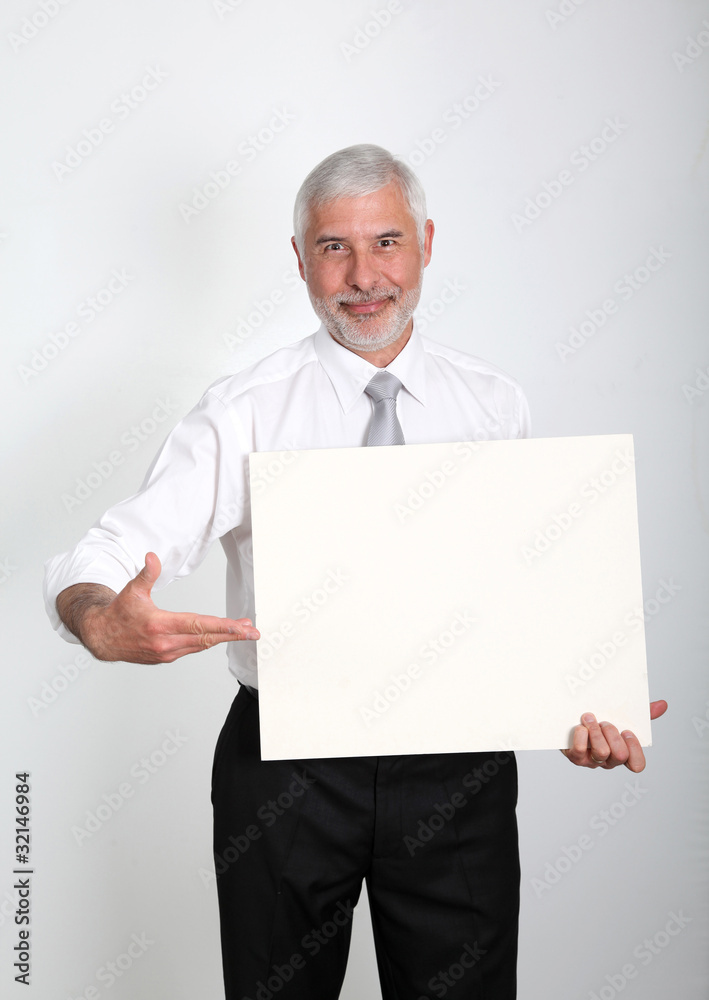 Businessman holding promotional message board Businessman holding promotional message board