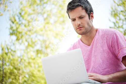 Handsome man with laptop outdoors