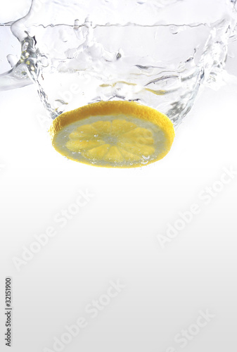 a lemon spashing in water