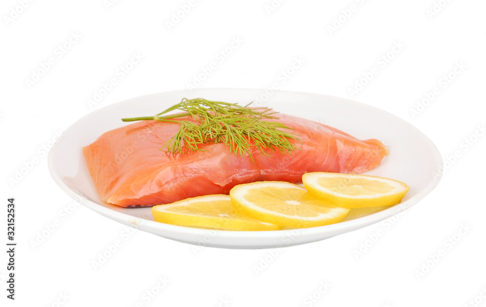 Fresh salmon steak with lemon slice and dill, isolated on white Fresh salmon steak with lemon slice and dill, isolated on white