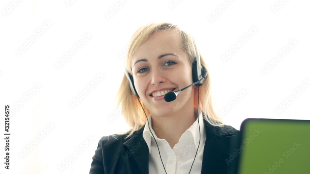 Attractive helpdesk consultant smiling to the camera Attractive helpdesk consultant smiling to the camera