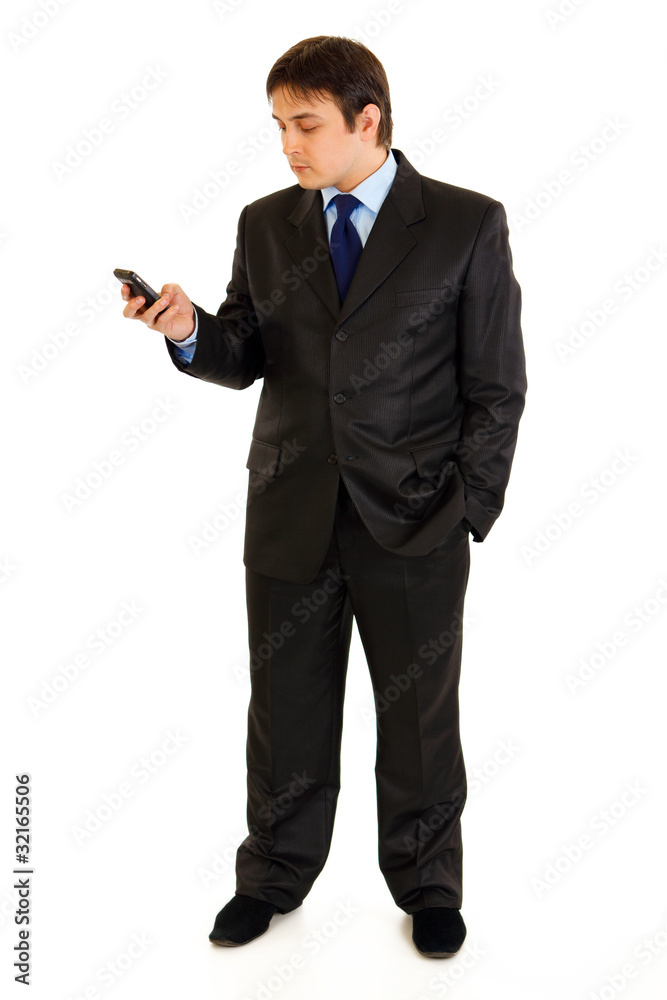 Full length portrait of businessman looking on mobile Full length portrait of businessman looking on mobile