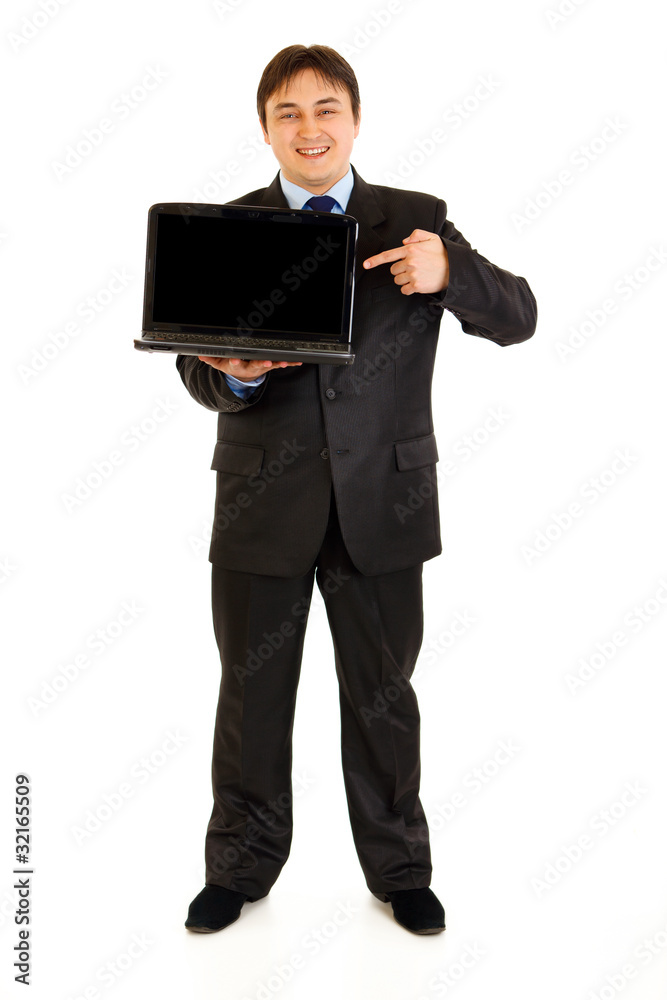 Smiling modern businessman pointing on laptops blank screen