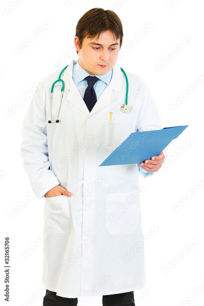 Concentrated medical doctor checking patients chart Concentrated medical doctor checking patients chart
