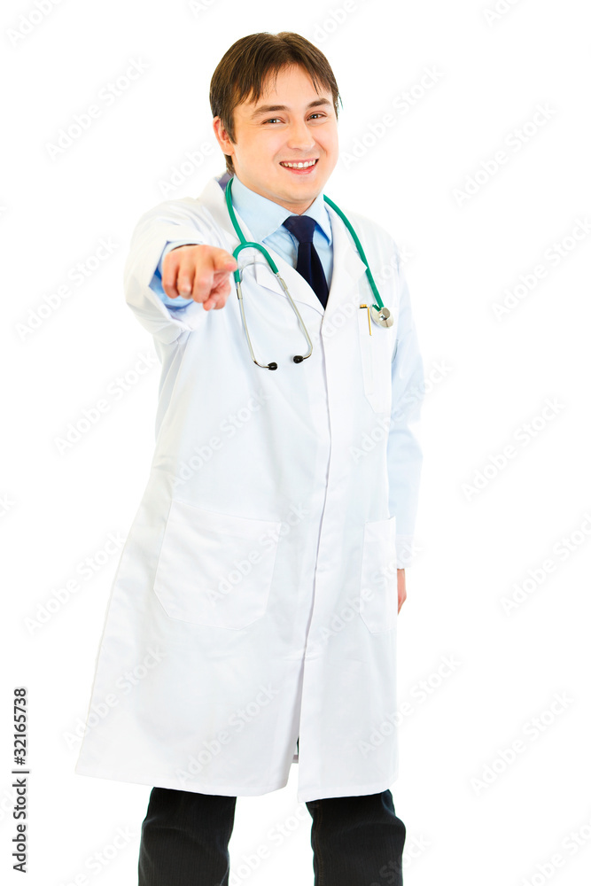 Smiling medical doctor pointing finger at you isolated on white. Smiling medical doctor pointing finger at you isolated on white.