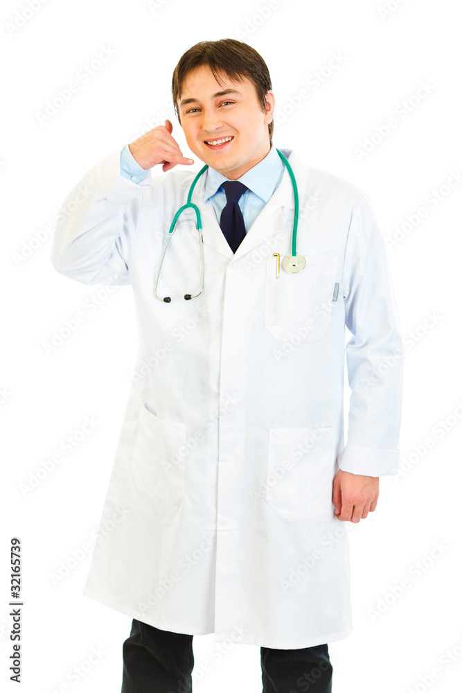 Smiling doctor showing contact me gesture isolated on white. Smiling doctor showing contact me gesture isolated on white.