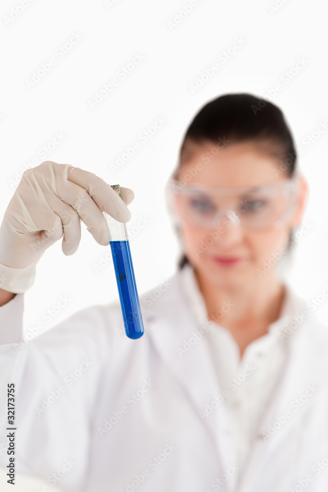 Isolated dark-haired scientist conducting an experiment Isolated dark-haired scientist conducting an experiment