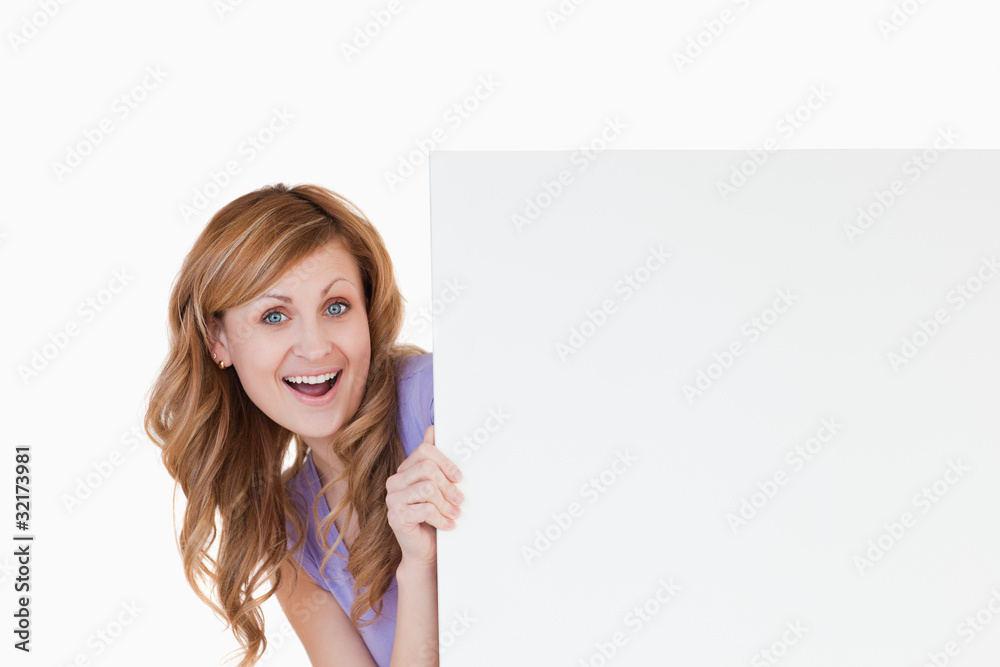 Smiling blond-haired woman holding a white board Smiling blond-haired woman holding a white board
