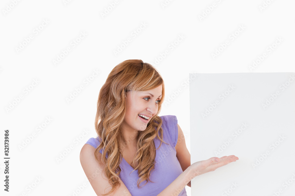 Lovely blond-haired woman holding a white board Lovely blond-haired woman holding a white board