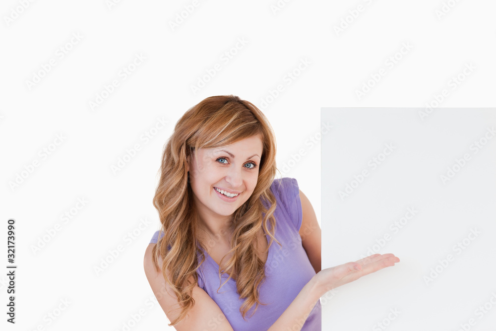 Happy blond-haired woman holding a white board Happy blond-haired woman holding a white board