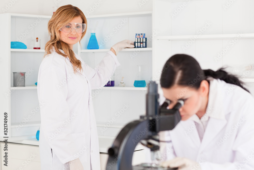 Two scientists conducting an experiment Two scientists conducting an experiment