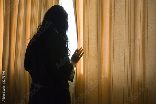 depressed woman by window photo