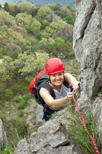 Female climber ascending a rock