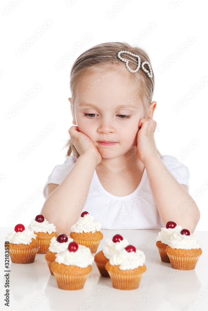 Closeup portrait of sweet little girl with cakes