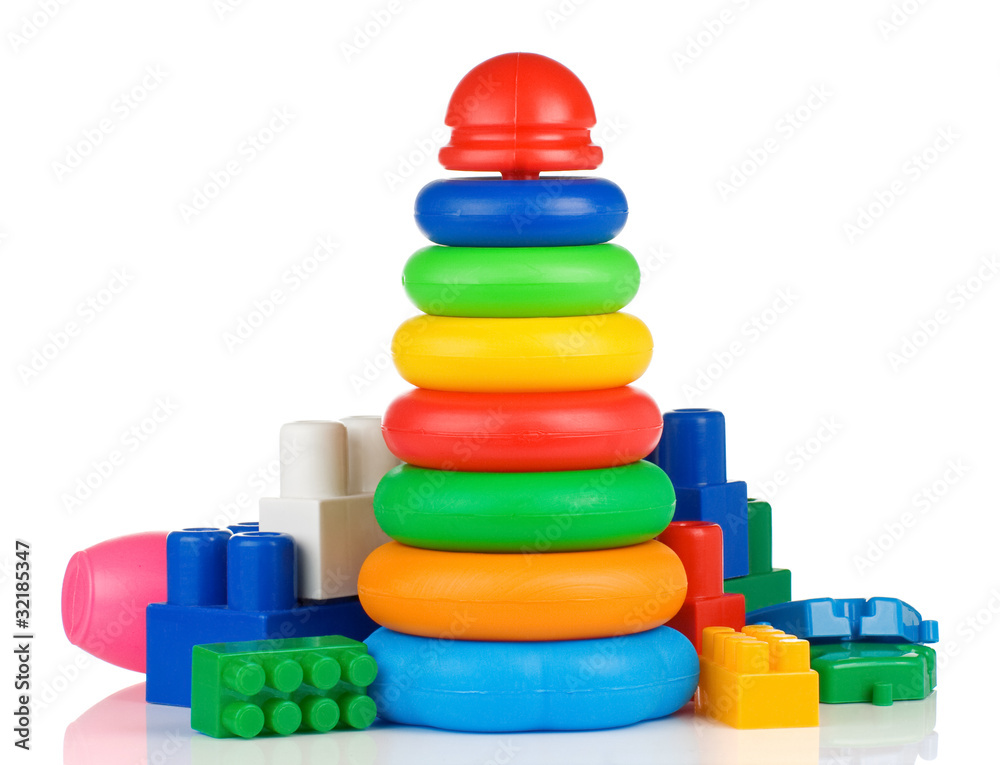 colorful plastic toys and bricks on white colorful plastic toys and bricks on white