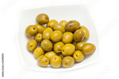green olives with a branch on a white background