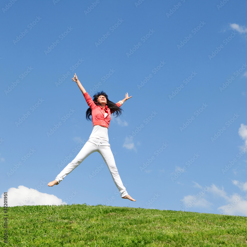 pretty young woman jumping on green grass pretty young woman jumping on green grass