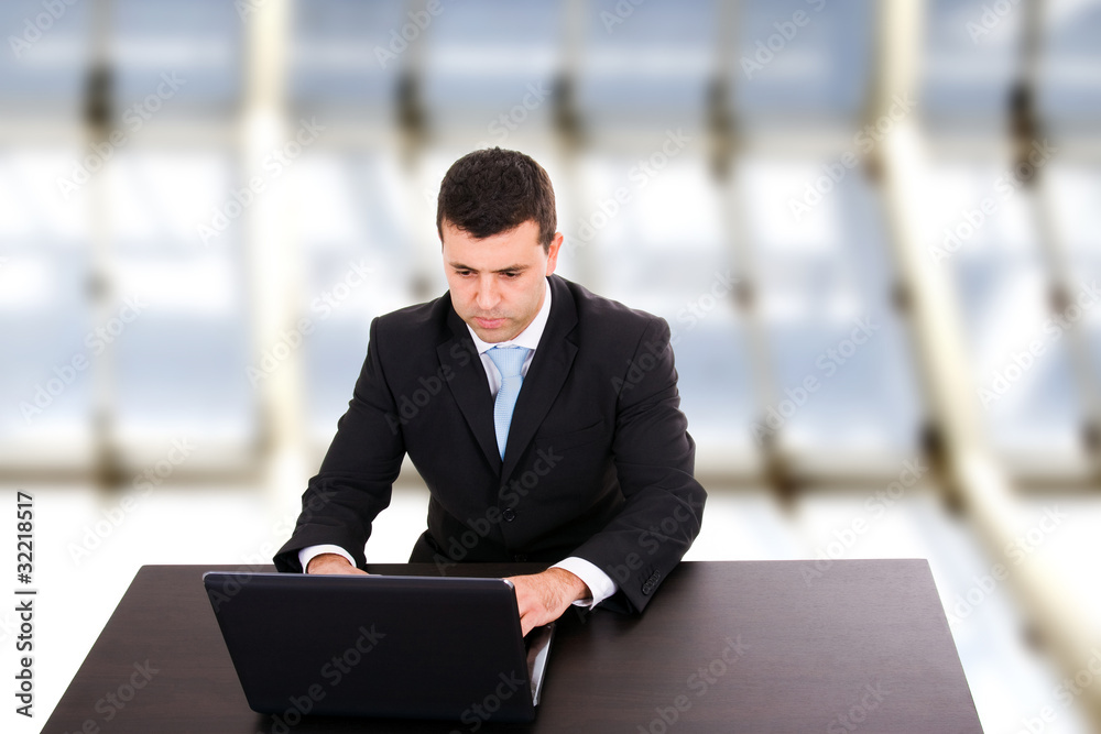 young business man working with is laptop at the office young business man working with is laptop at the office