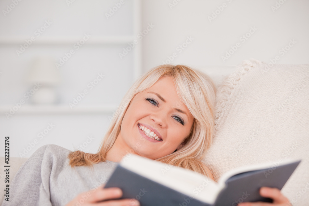 A cute blond woman reading a book A cute blond woman reading a book
