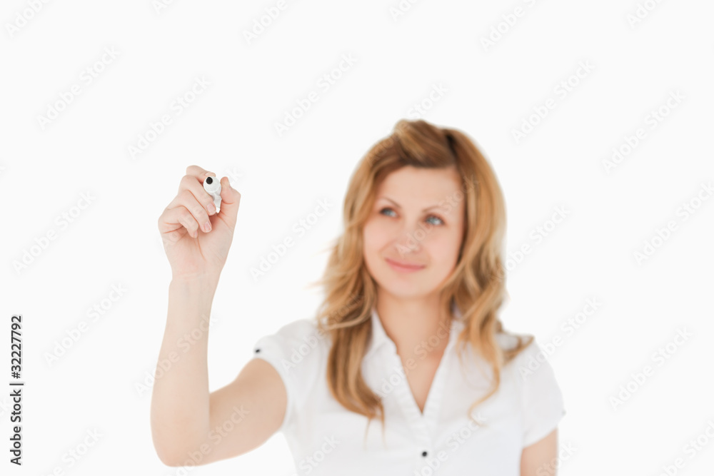 Blonde woman drawing a scheme looking towards the camera