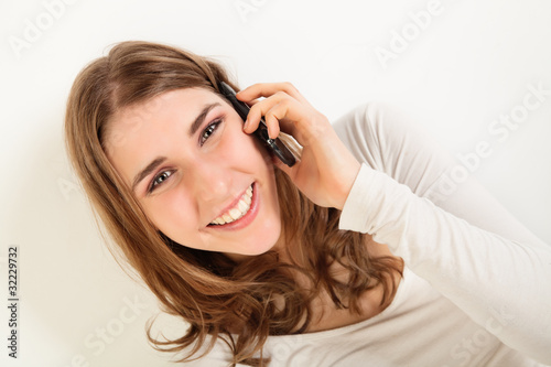 Smiling young woman with phone