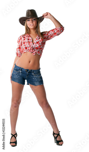 Beautiful sexy cowgirl stand in shorts isolated