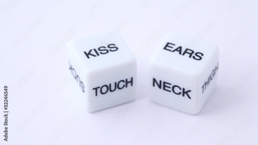 white dice with erotic messages on the sides, rotating on white white dice with erotic messages on the sides, rotating on white