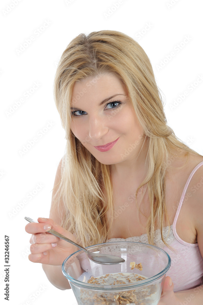 Pretty woman having muesli cereals for breakfast. isolated on wh Pretty woman having muesli cereals for breakfast. isolated on wh