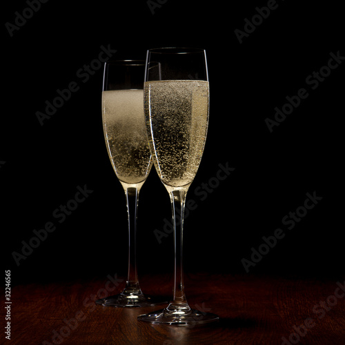 two glass with champagne on a wooden table
