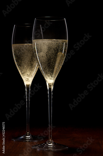 two glass with champagne on a wooden table