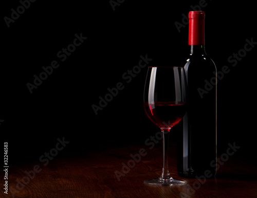 Wine glass and Bottle on a wooden table