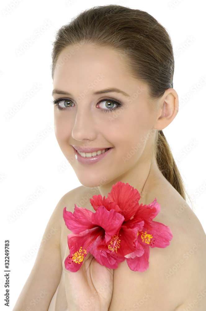 Beauty and health of young woman with flower of hibiscus Beauty and health of young woman with flower of hibiscus