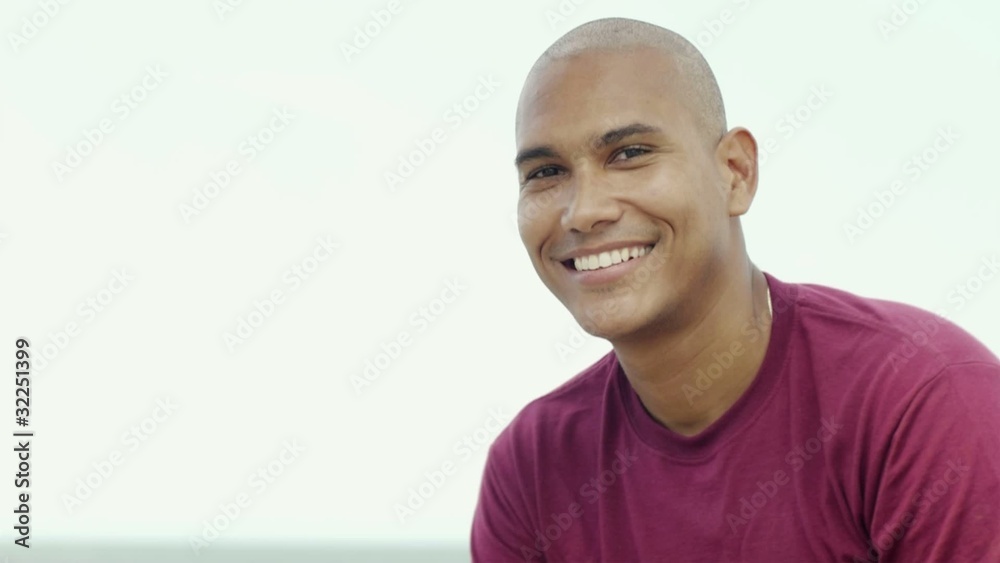 young latino man smiling at camera young latino man smiling at camera
