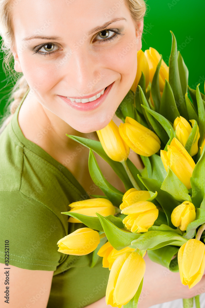 Young woman hold yellow tulips flower Young woman hold yellow tulips flower