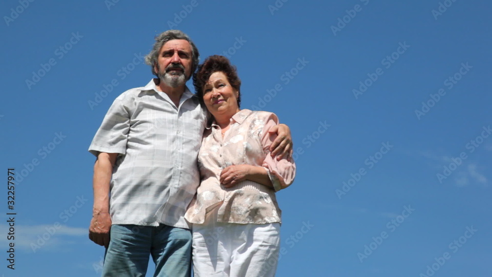 couple stands embrace and show off somewhere hands against sky couple stands embrace and show off somewhere hands against sky