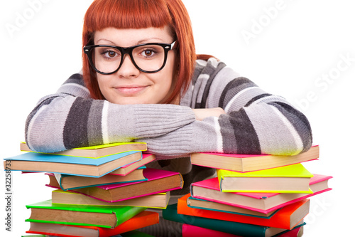 teenage resting on stack of books