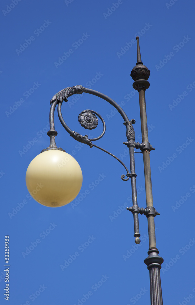 old streetlight with blue sky