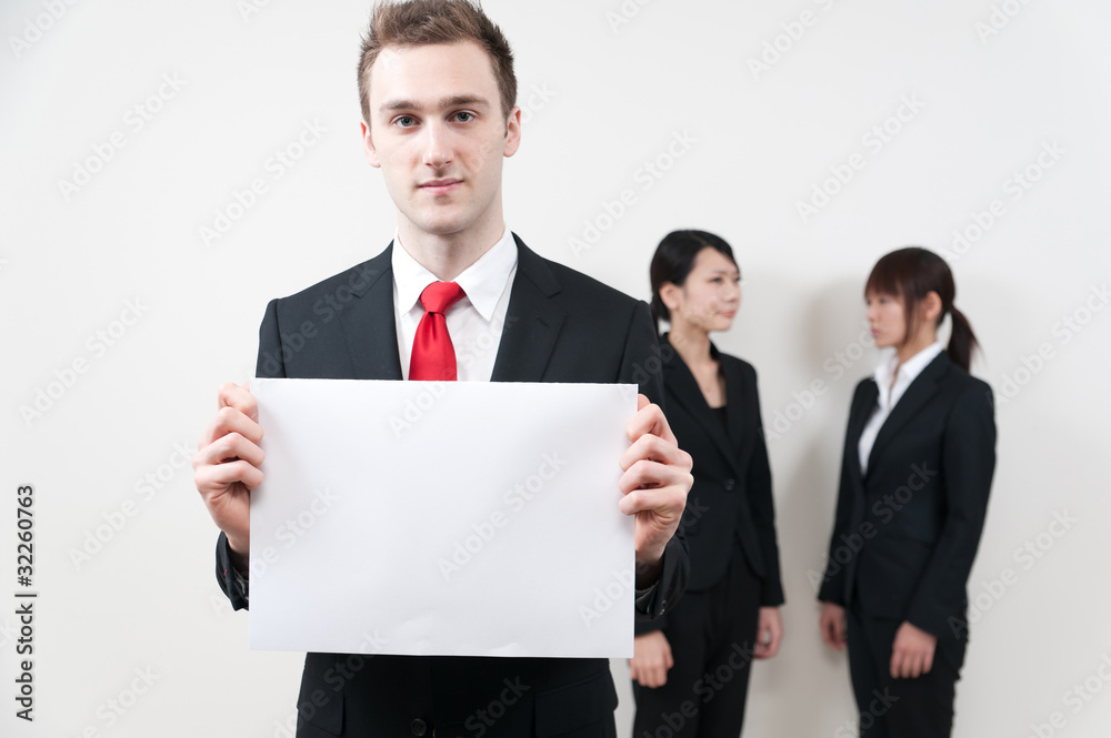 a young businessman holding a blank whiteboard a young businessman holding a blank whiteboard
