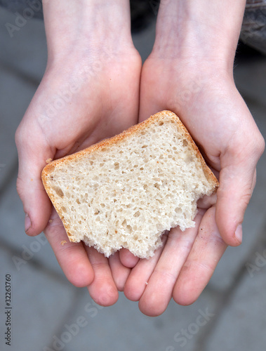A child holding a piece of bread