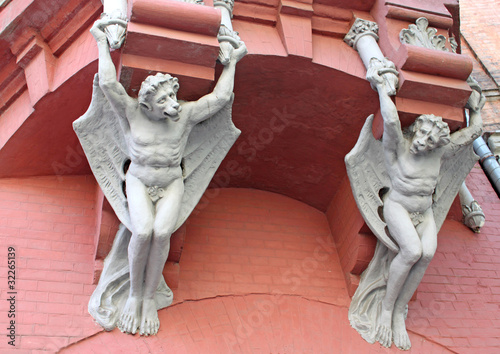 Architecture demon with wings on wall of house in Kiev, Ukraine photo