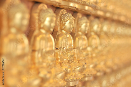 A lot of chinese buddhas statue full frame. photo