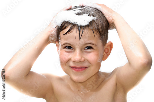 A boy swims in the bathtub