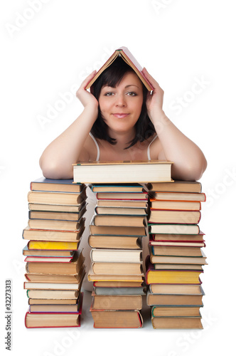 Young smiling woman with heap of books