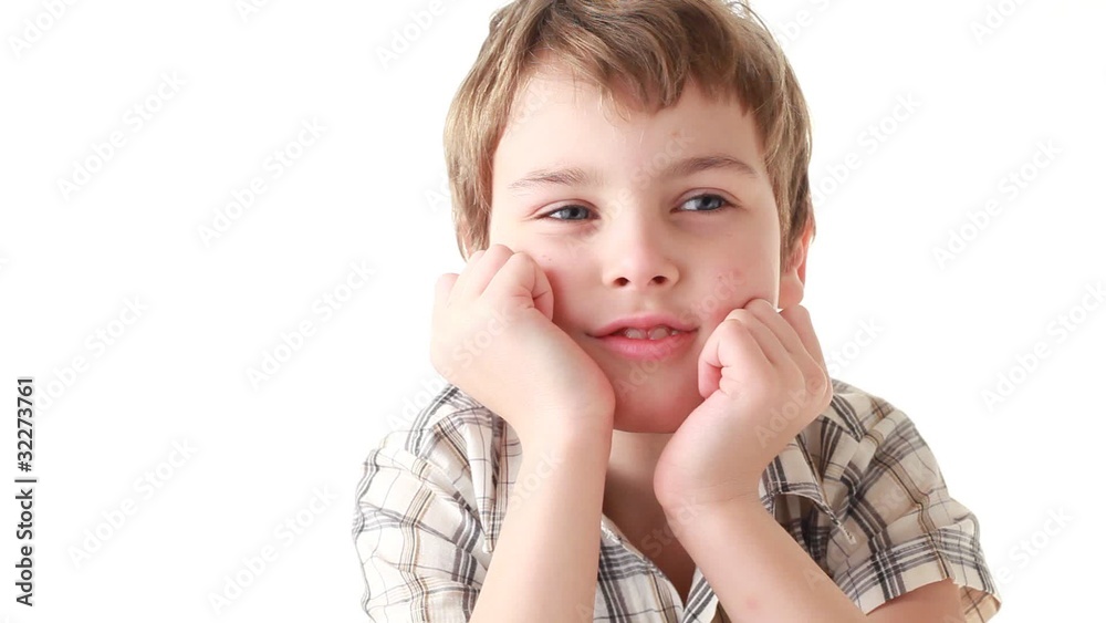 Boy supports the head in his hands laughing and goggle Boy supports the head in his hands laughing and goggle