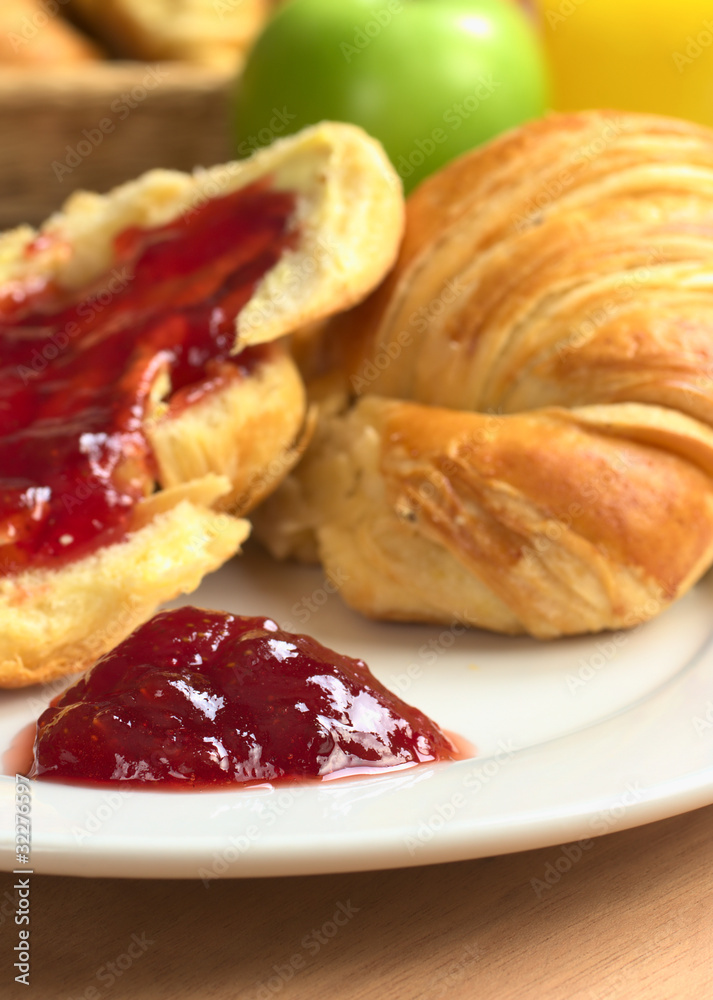 Strawberry jam on plate with croissant Strawberry jam on plate with croissant