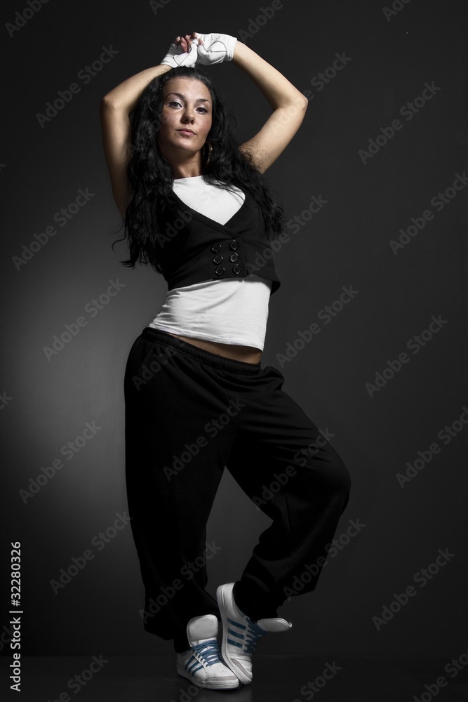 young female dancing on the black background