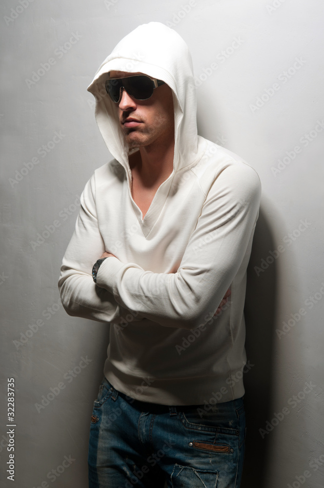 man with athletic standing near a wall man with athletic standing near a wall
