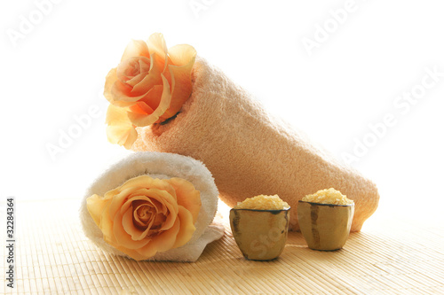 A spa composition of flowers, healthy salt and two towels