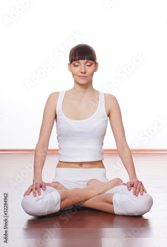 A young Caucasian woman is doing a stretching exercise