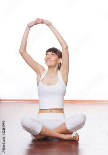A young Caucasian woman is doing a stretching exercise